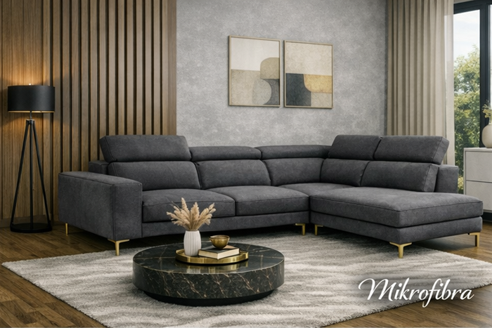 Nowoczesny narożnik tapicerowany tkaniną mikrofibra w ciemnoszarym odcieniu, ustawiony w eleganckim salonie z marmurowym stolikiem, drewnianą podłogą i minimalistycznymi dekoracjami.