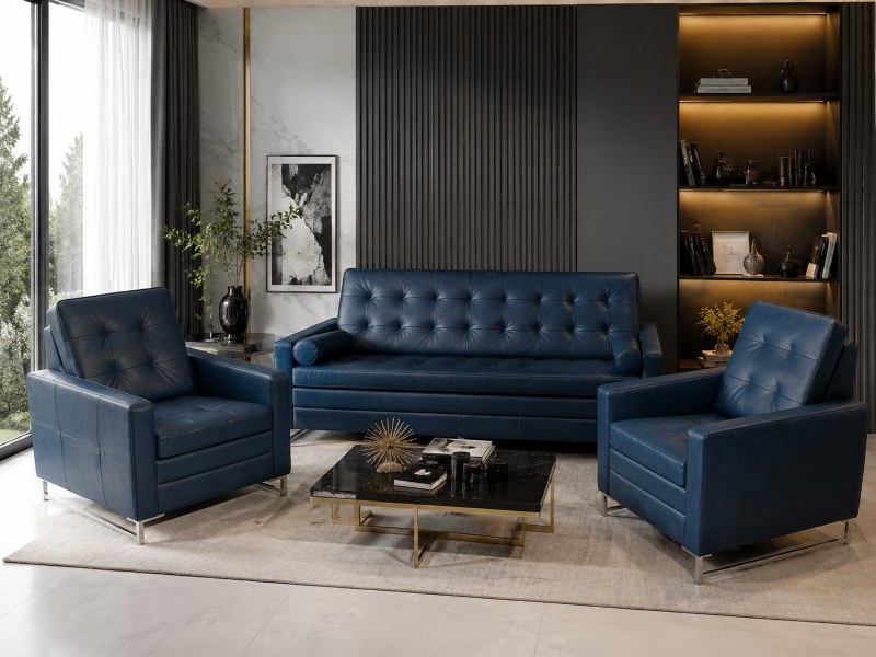 Granatowy zestaw wypoczynkowy M053 firmy Mebel Akimo — sofa i fotele z pikowaną tapicerką oraz metalowymi nogami, ustawione w eleganckim salonie z marmurowym stolikiem i podświetlaną ścianą.